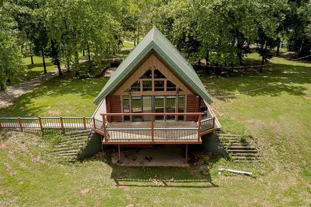 1000 N Canadian Ave, Purcell, OK 73080 - rear view of house with log exterior, a yard, and a wooden deck