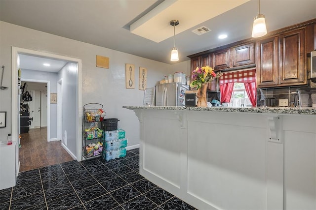 2022 NW 30th St, Oklahoma City, OK 73118 - kitchen with freestanding refrigerator, a breakfast bar, pendant lighting, backsplash, and recessed lighting