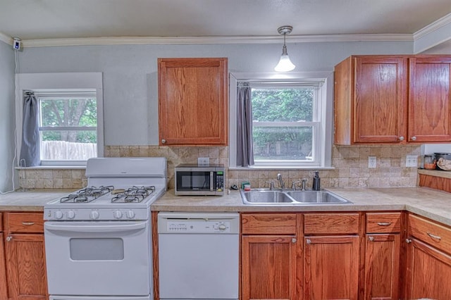 912 E Comanche St, Norman, OK 73071 - kitchen featuring white appliances, a sink, plenty of natural light, backsplash, and ornamental molding