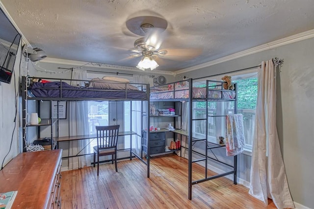 912 E Comanche St, Norman, OK 73071 - bedroom featuring hardwood / wood-style flooring, a textured ceiling, crown molding, and baseboards