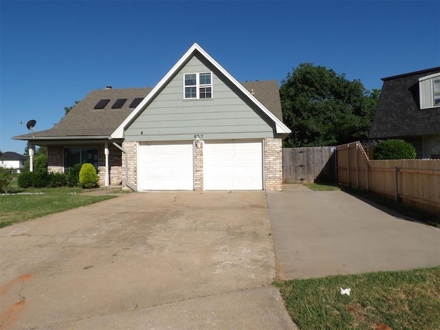 8317 NW 27th St, Bethany, OK 73008 - traditional home with driveway, brick siding, and a shingled roof