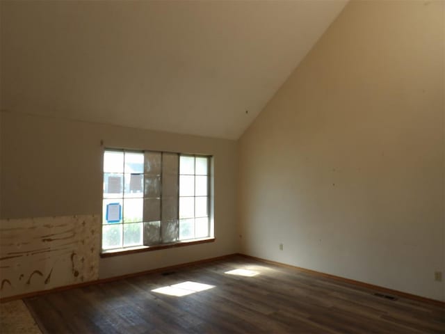 8317 NW 27th St, Bethany, OK 73008 - unfurnished room featuring vaulted ceiling, wood finished floors, and baseboards