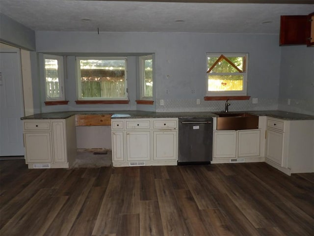 8317 NW 27th St, Bethany, OK 73008 - kitchen with dishwasher, a sink, dark wood-style flooring, white cabinets, and dark countertops