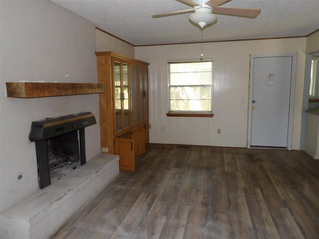 8317 NW 27th St, Bethany, OK 73008 - unfurnished living room with ceiling fan, wood finished floors, a textured ceiling, and ornamental molding
