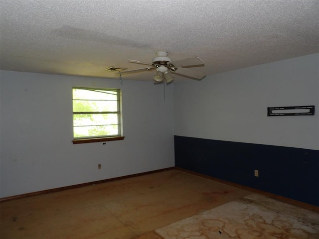 8317 NW 27th St, Bethany, OK 73008 - empty room with a textured ceiling, a ceiling fan, and baseboards