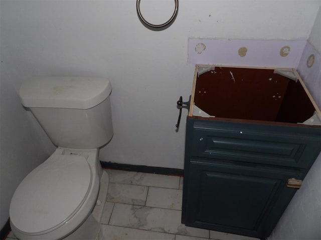 8317 NW 27th St, Bethany, OK 73008 - bathroom featuring toilet, marble look tile flooring, baseboards, and vanity