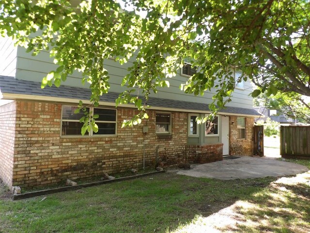 8317 NW 27th St, Bethany, OK 73008 - rear view of property with brick siding, a patio, and roof with shingles