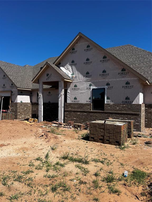 4333 Courtlyn Ave, Tuttle, OK 73089 - view of home's exterior with brick siding and roof with shingles