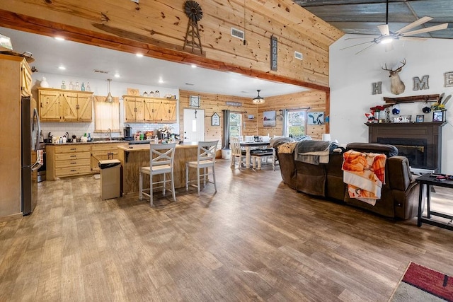 2645 E 2090th Rd, Hugo, OK 74743 - kitchen with freestanding refrigerator, wood finished floors, ceiling fan, open floor plan, and a high ceiling