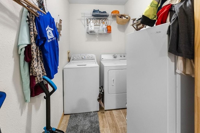 2645 E 2090th Rd, Hugo, OK 74743 - laundry room with separate washer and dryer and wood finished floors