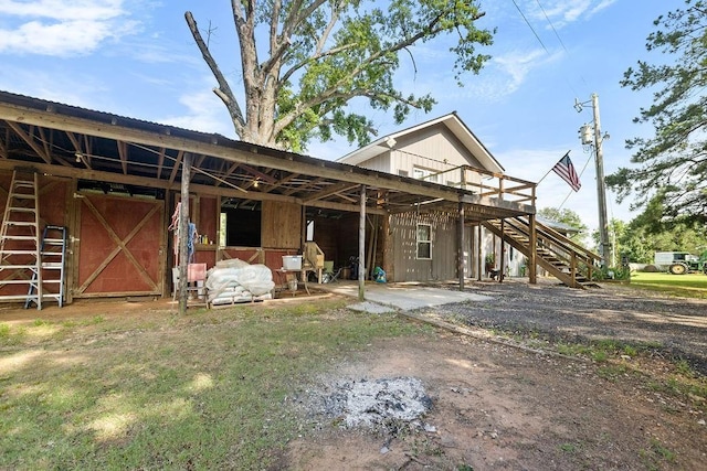 2645 E 2090th Rd, Hugo, OK 74743 - rear view of house featuring stairway, an exterior structure, and an outdoor structure