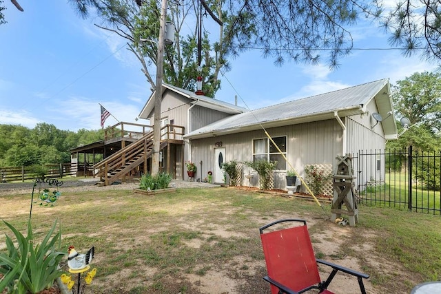2645 E 2090th Rd, Hugo, OK 74743 - view of front of house featuring stairs, a wooden deck, and metal roof