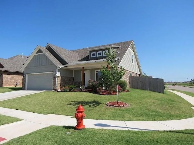 8332 NW 139 Th Ter, Oklahoma City, OK 73142 - view of front of house featuring an attached garage, board and batten siding, driveway, and brick siding