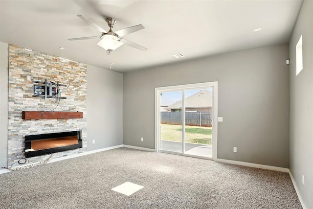 8332 NW 139 Th Ter, Oklahoma City, OK 73142 - unfurnished living room with carpet flooring, a ceiling fan, a fireplace, and baseboards