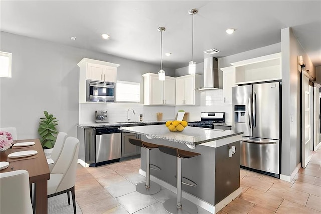 8332 NW 139 Th Ter, Oklahoma City, OK 73142 - kitchen featuring appliances with stainless steel finishes, wall chimney exhaust hood, a sink, tasteful backsplash, and a center island
