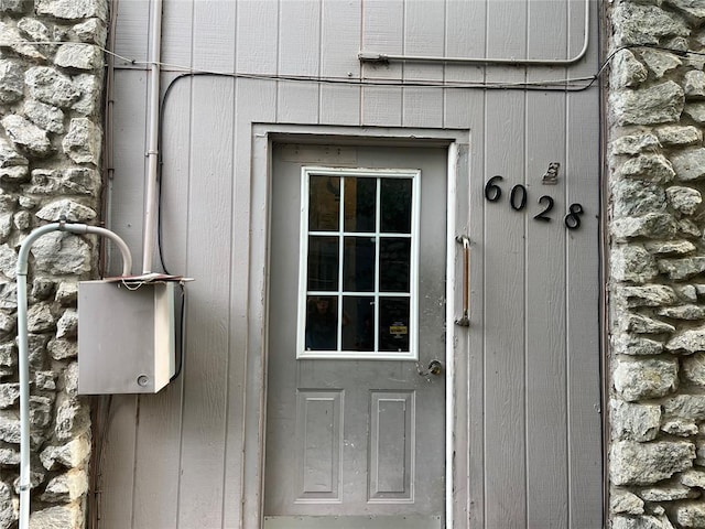 doorway to property featuring stone siding