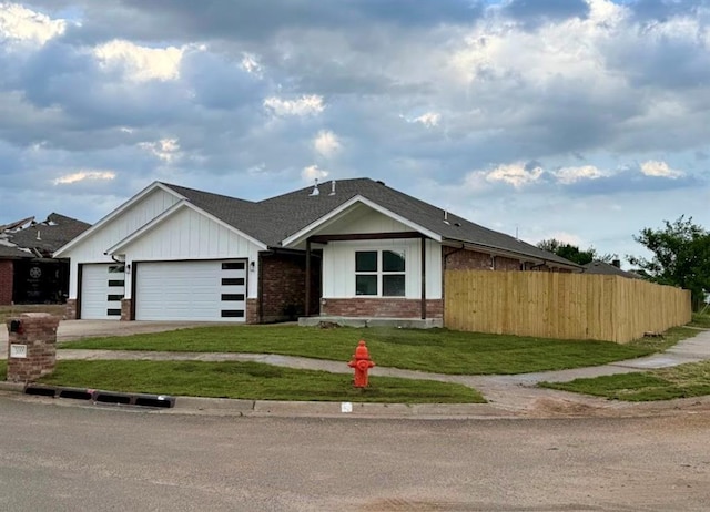5000 SE 85th St, Oklahoma City, OK 73135 - view of front of home featuring a garage, brick siding, driveway, and a shingled roof