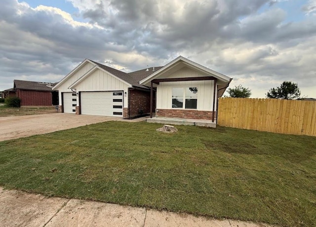 5000 SE 85th St, Oklahoma City, OK 73135 - view of front of house with a garage, board and batten siding, concrete driveway, and brick siding