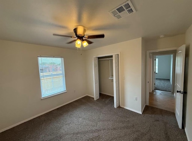 5000 SE 85th St, Oklahoma City, OK 73135 - unfurnished bedroom with dark carpet, baseboards, a ceiling fan, and a closet