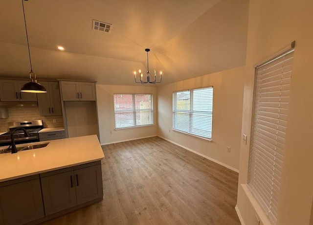 5000 SE 85th St, Oklahoma City, OK 73135 - kitchen featuring a sink, decorative backsplash, light countertops, a chandelier, and baseboards