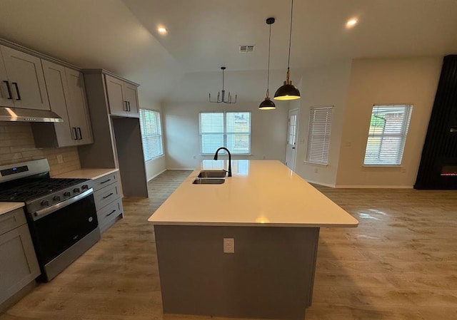5000 SE 85th St, Oklahoma City, OK 73135 - kitchen with stainless steel gas range oven, under cabinet range hood, a sink, light wood finished floors, and recessed lighting