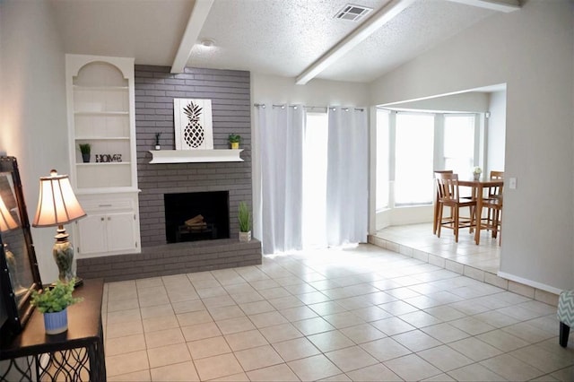3012 SE 55th St, Oklahoma City, OK 73135 - living area with beam ceiling, light tile patterned flooring, a textured ceiling, a fireplace, and built in shelves
