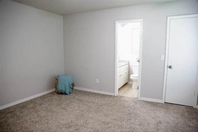 3012 SE 55th St, Oklahoma City, OK 73135 - unfurnished bedroom featuring light carpet, baseboards, and ensuite bathroom