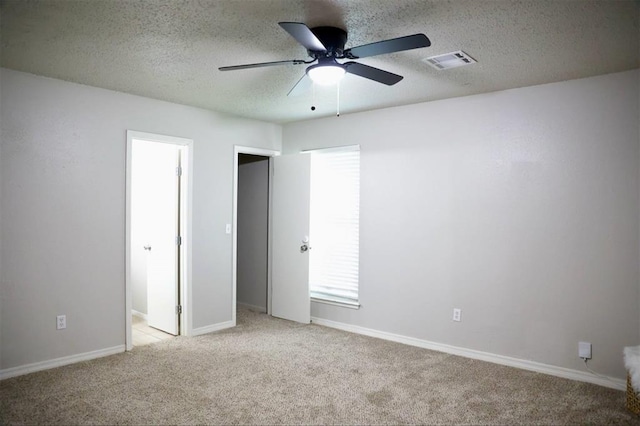 3012 SE 55th St, Oklahoma City, OK 73135 - unfurnished bedroom with light colored carpet, a textured ceiling, baseboards, and ceiling fan