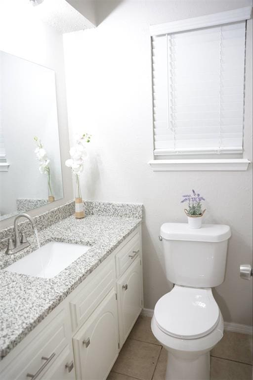 3012 SE 55th St, Oklahoma City, OK 73135 - bathroom featuring vanity, toilet, tile patterned floors, and baseboards