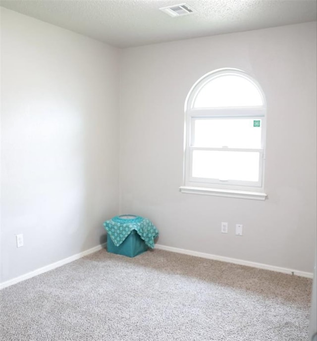 3012 SE 55th St, Oklahoma City, OK 73135 - carpeted empty room featuring baseboards and a textured ceiling
