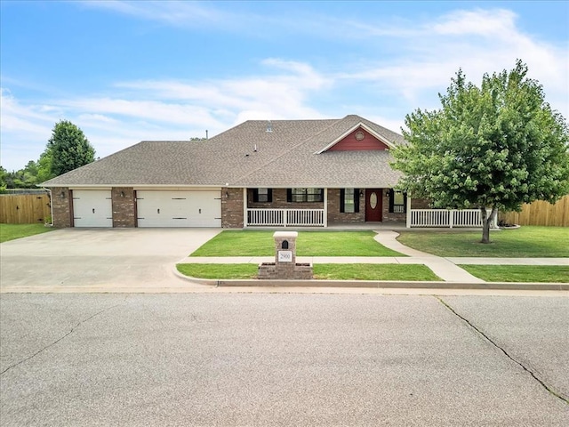 2900 Coventry Manor Dr, Oklahoma City, OK 73128 - view of front facade with brick siding, concrete driveway, a garage, covered porch, and a shingled roof