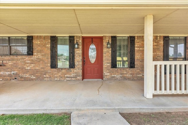 2900 Coventry Manor Dr, Oklahoma City, OK 73128 - doorway to property featuring a porch and brick siding