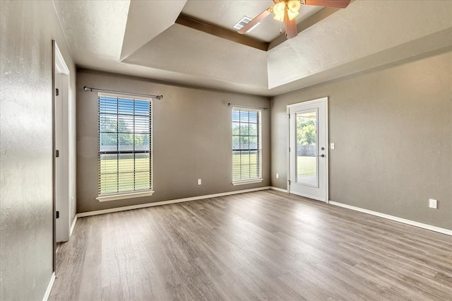 2900 Coventry Manor Dr, Oklahoma City, OK 73128 - unfurnished room with a tray ceiling, wood finished floors, ceiling fan, baseboards, and a textured wall