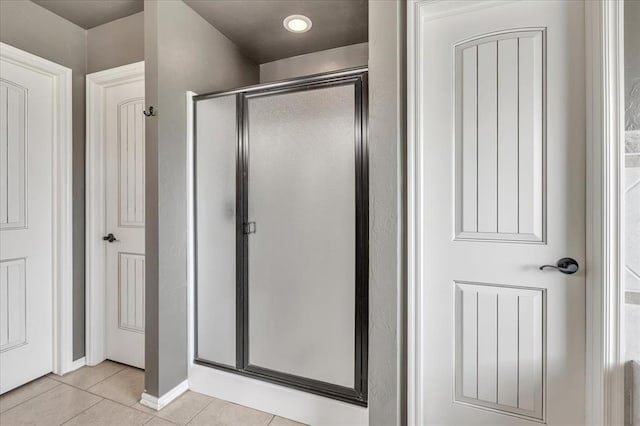 2900 Coventry Manor Dr, Oklahoma City, OK 73128 - bathroom with a stall shower, tile patterned flooring, and baseboards
