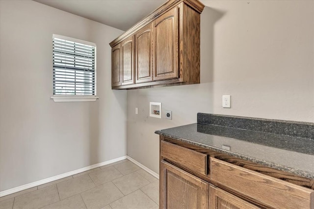 2900 Coventry Manor Dr, Oklahoma City, OK 73128 - washroom with electric dryer hookup, washer hookup, cabinet space, baseboards, and light tile patterned floors
