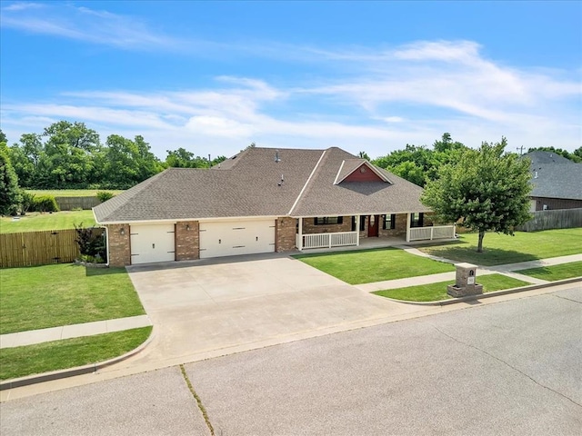 2900 Coventry Manor Dr, Oklahoma City, OK 73128 - view of front of home with covered porch, brick siding, a garage, driveway, and roof with shingles