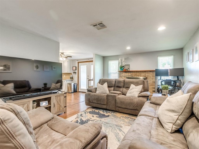 625 Jasmine Pl, Edmond, OK 73003 - living area with light wood-type flooring, healthy amount of natural light, recessed lighting, ceiling fan, and french doors