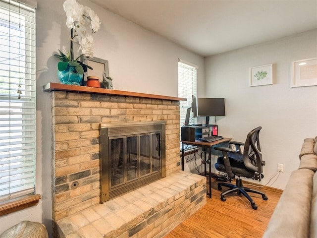 625 Jasmine Pl, Edmond, OK 73003 - office featuring wood finished floors, a brick fireplace, and baseboards