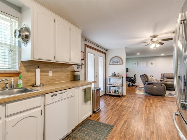 625 Jasmine Pl, Edmond, OK 73003 - kitchen featuring dishwasher, a sink, white cabinetry, backsplash, and a ceiling fan