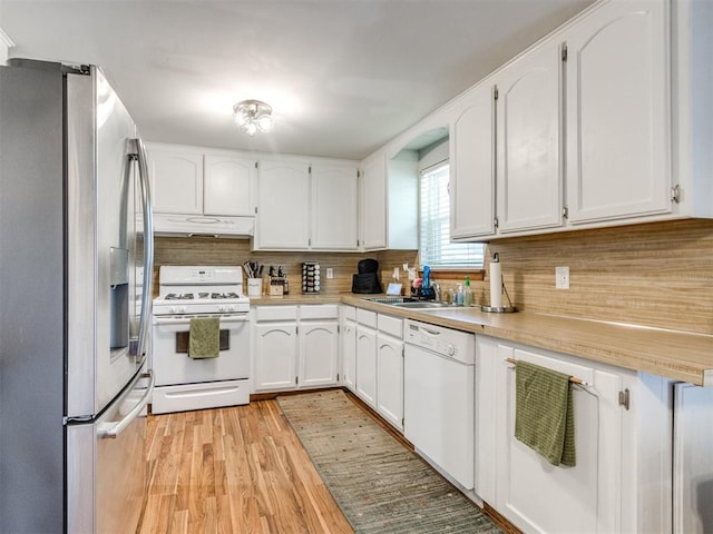 625 Jasmine Pl, Edmond, OK 73003 - kitchen with white appliances, light countertops, decorative backsplash, white cabinetry, and light wood-type flooring