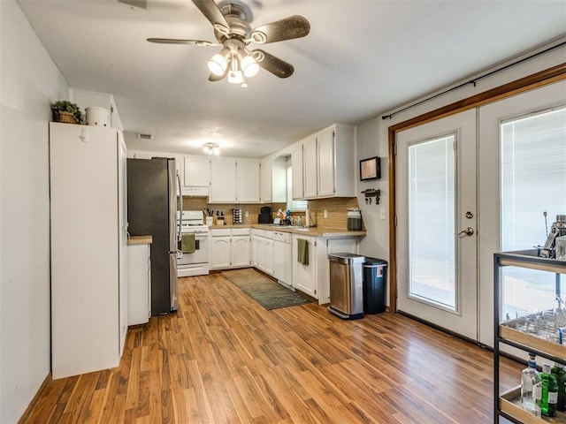 625 Jasmine Pl, Edmond, OK 73003 - kitchen with white appliances, light wood-style floors, white cabinets, light countertops, and a ceiling fan