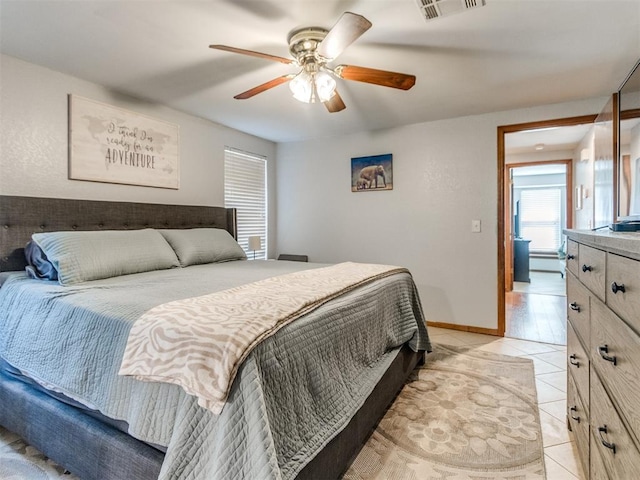 625 Jasmine Pl, Edmond, OK 73003 - bedroom featuring light tile patterned flooring, ceiling fan, and baseboards