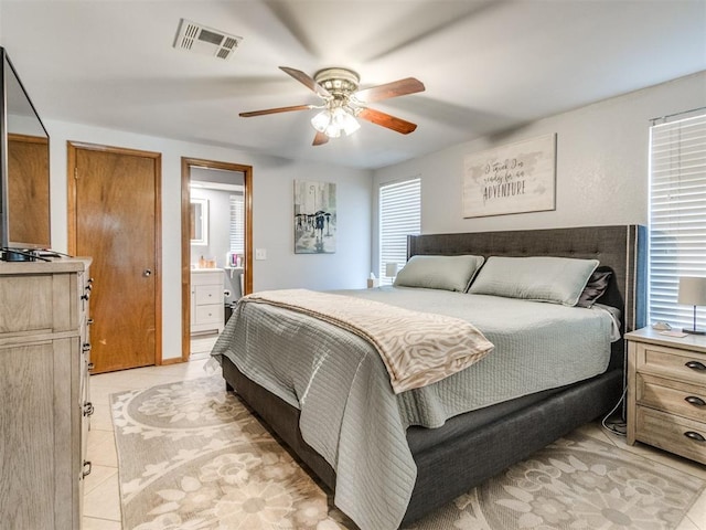625 Jasmine Pl, Edmond, OK 73003 - bedroom with ceiling fan, light tile patterned floors, and ensuite bathroom