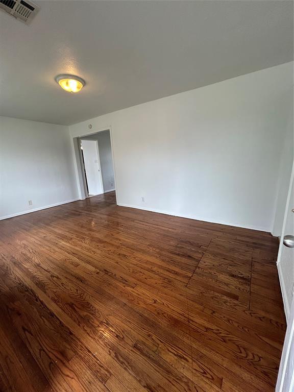 4404 N State St, Warr Acres, OK 73122 - spare room with dark wood-style flooring and baseboards