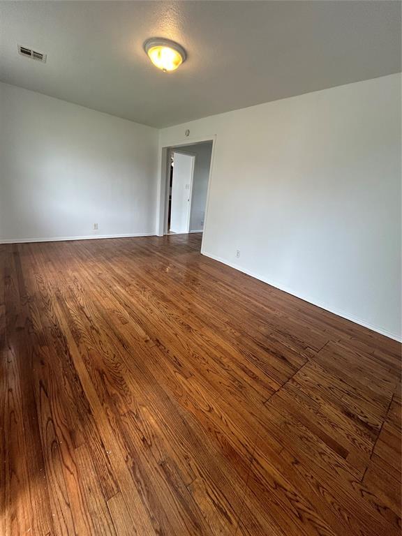 4404 N State St, Warr Acres, OK 73122 - spare room with dark wood-style flooring and baseboards