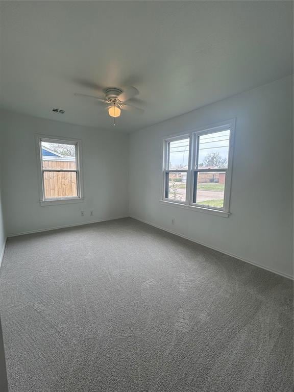 4404 N State St, Warr Acres, OK 73122 - unfurnished room featuring healthy amount of natural light, a ceiling fan, carpet floors, and baseboards