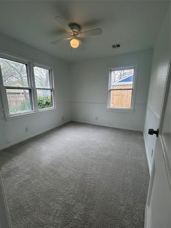 4404 N State St, Warr Acres, OK 73122 - empty room with healthy amount of natural light, a ceiling fan, carpet floors, and baseboards