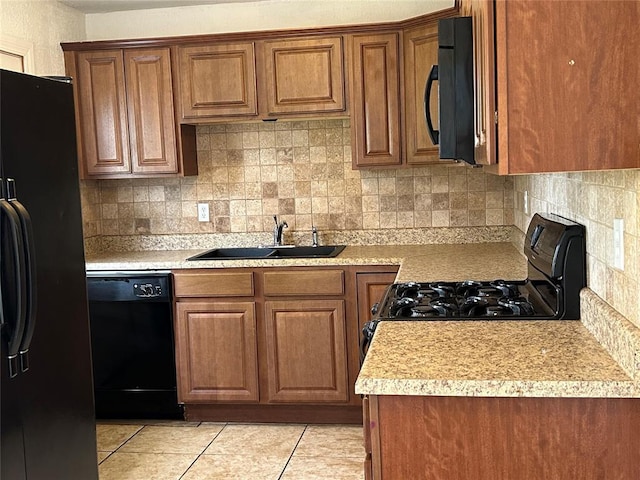 4404 N State St, Warr Acres, OK 73122 - kitchen with black appliances, a sink, and brown cabinets