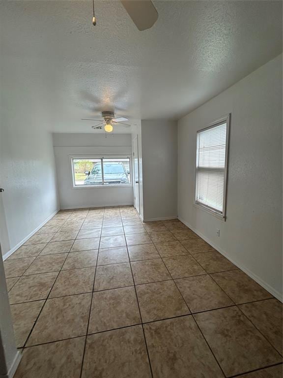 4404 N State St, Warr Acres, OK 73122 - unfurnished room with ceiling fan, a textured ceiling, tile patterned flooring, and baseboards