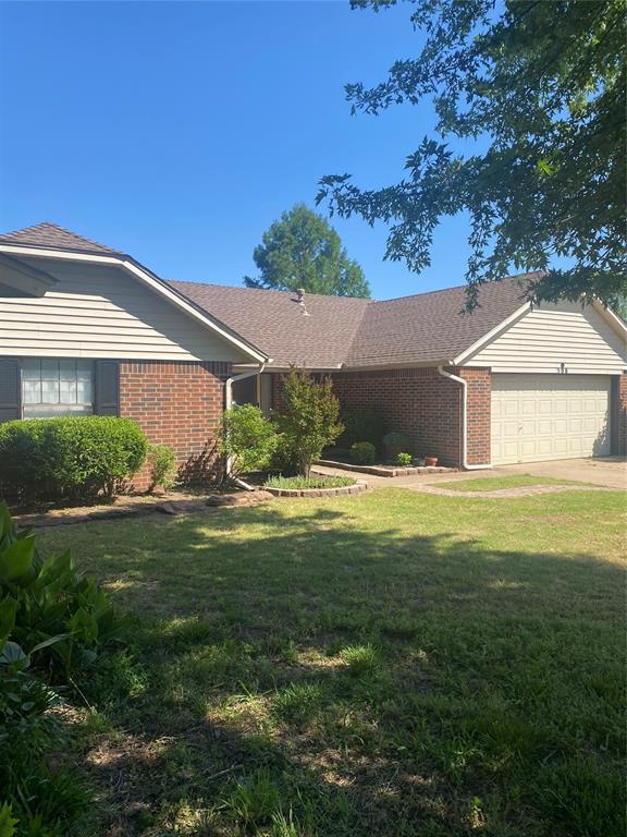 308 Jeffrey Laird Pl, Moore, OK 73160 - ranch-style home with brick siding, a garage, a front lawn, and concrete driveway